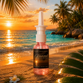 Bottle of Bronzed Rose Mist on a tropical beach at sunset