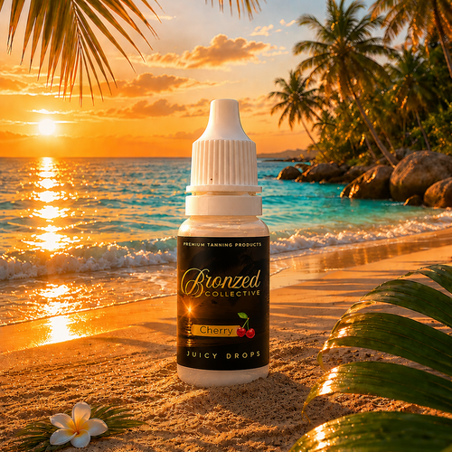 Bronzed Collective Cherry Juicy Drops bottle on a beach with sunset and palm trees in the background